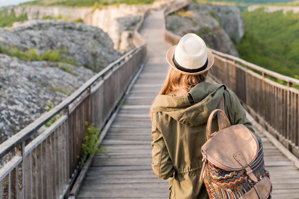 back-view-stylish-traveller-with-hat-walking